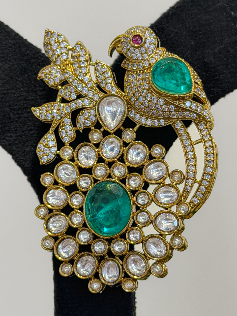 Ornate brooch with emeralds and diamonds