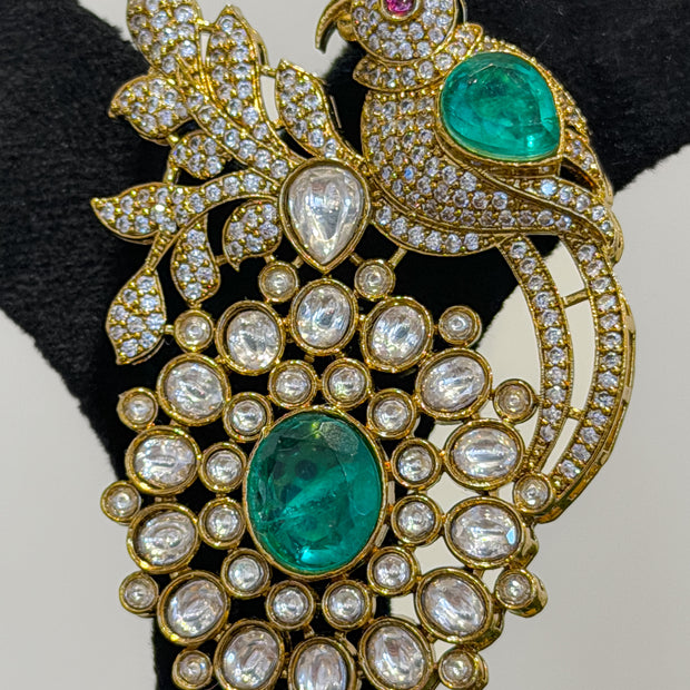 Ornate brooch with emeralds and diamonds