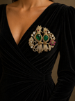 Black velvet dress with a large ornate brooch