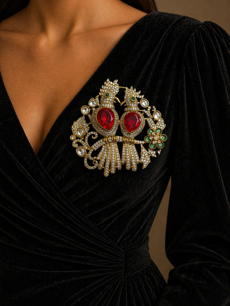 Close-up of a black dress with a large, ornate brooch 