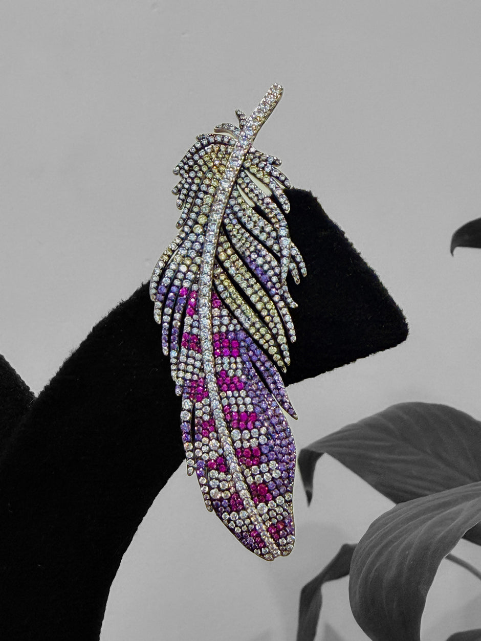 Feather-shaped earring with purple and pink gemstones