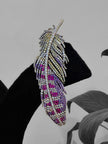 Feather-shaped earring with purple and pink gemstones
