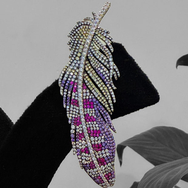 Feather-shaped earring with purple and pink gemstones