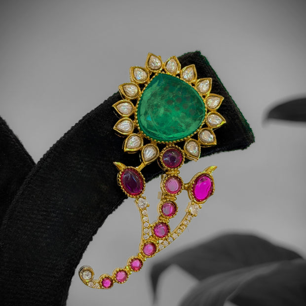 Jewelry piece with emerald and pink gemstones