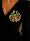 Jeweled brooch with green gemstones