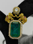 Gold brooch with green gemstone and pink stones