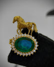 Gold horse pendant with a green gemstone 