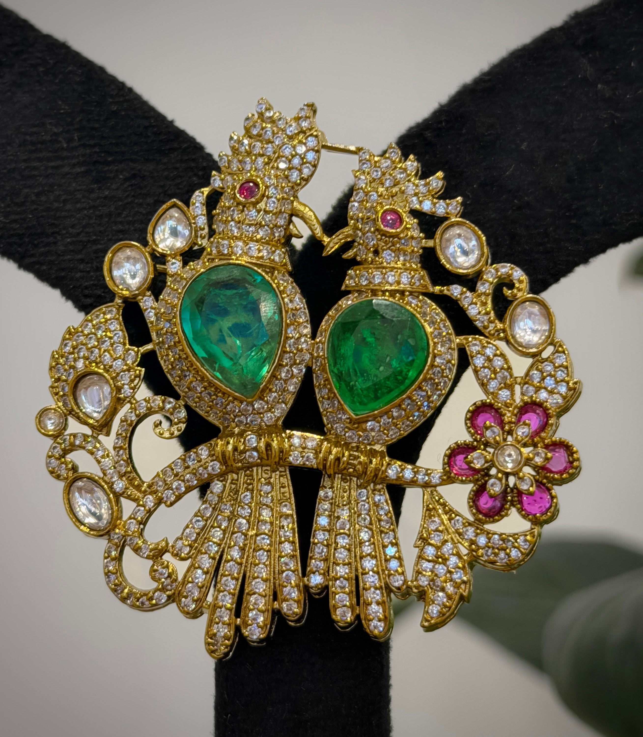 Ornate gold earrings with green gemstones 
