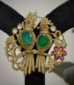 Ornate gold earrings with green gemstones 