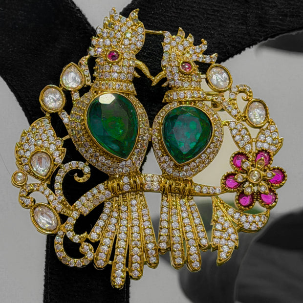 Ornate gold earrings with green gemstones 