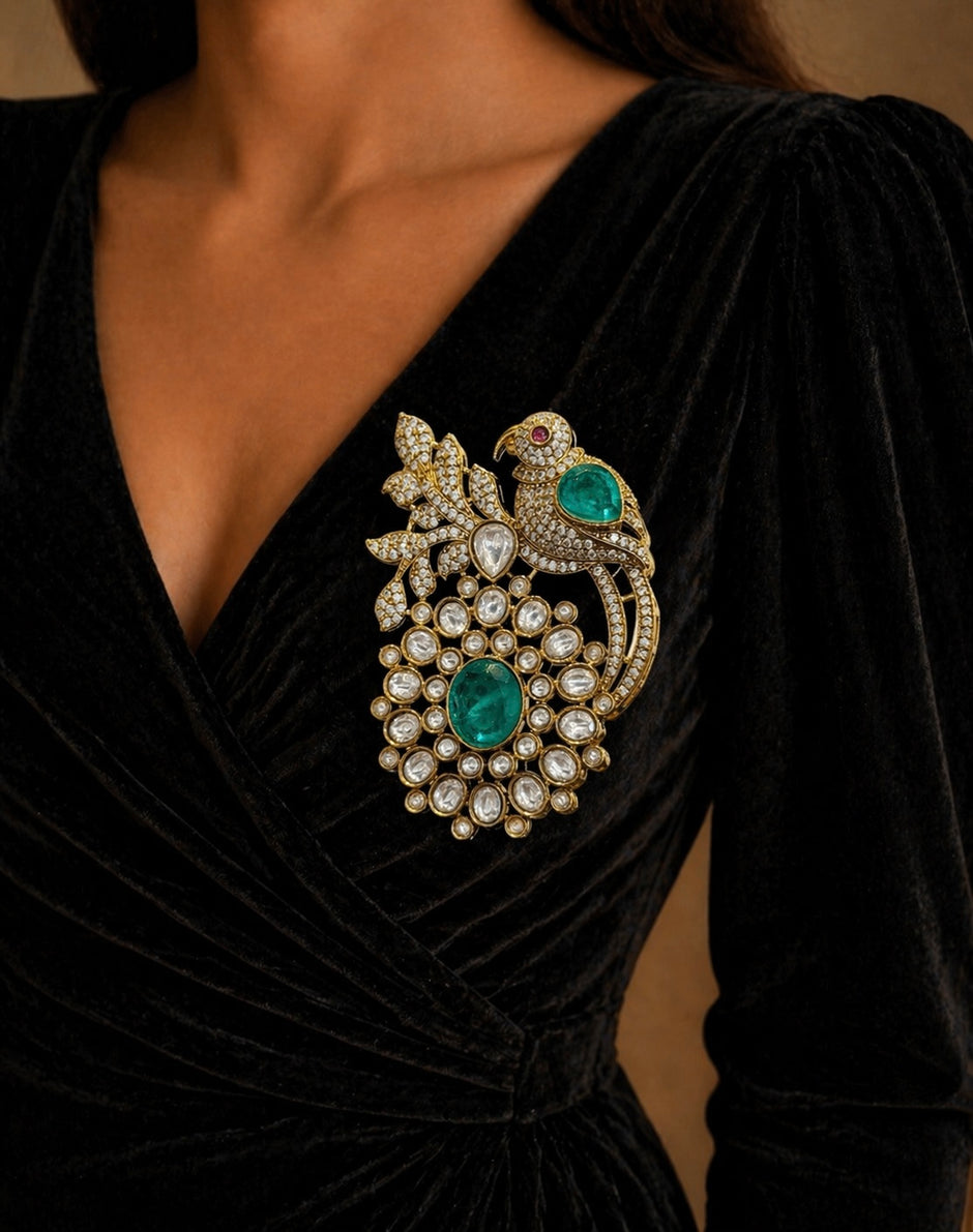 Close-up of a black dress with a decorative brooch 