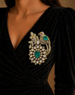 Close-up of a black dress with a decorative brooch 