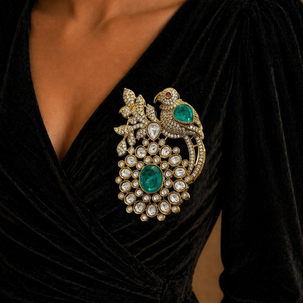 Close-up of a black dress with a decorative brooch 