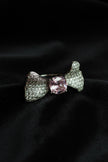 Silver bow-shaped ring with a pink gemstone