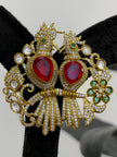 Ornate brooch with red stones 