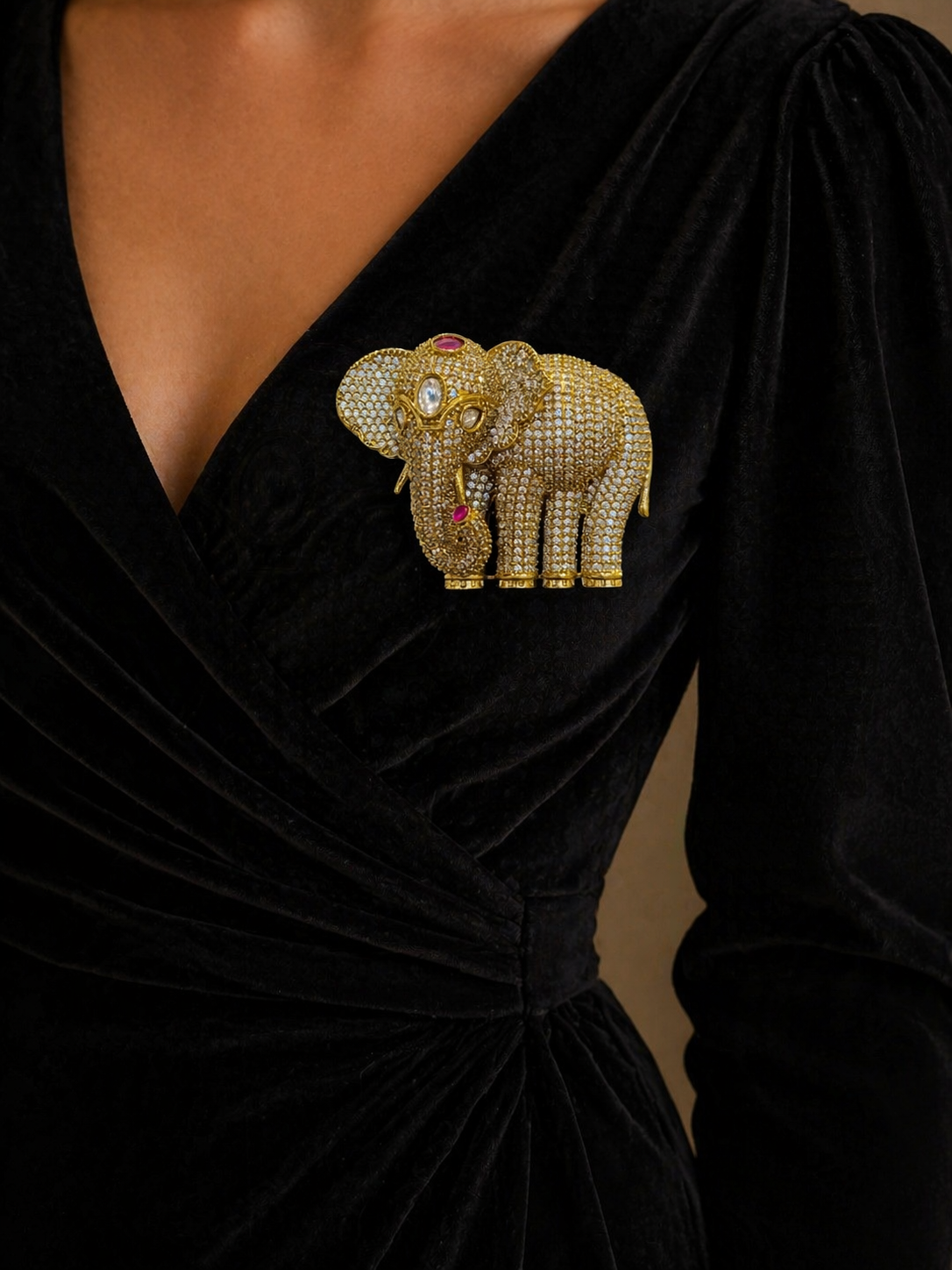 Black dress with a decorative elephant brooch 