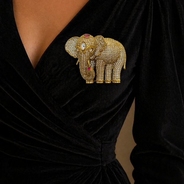 Black dress with a decorative elephant brooch 