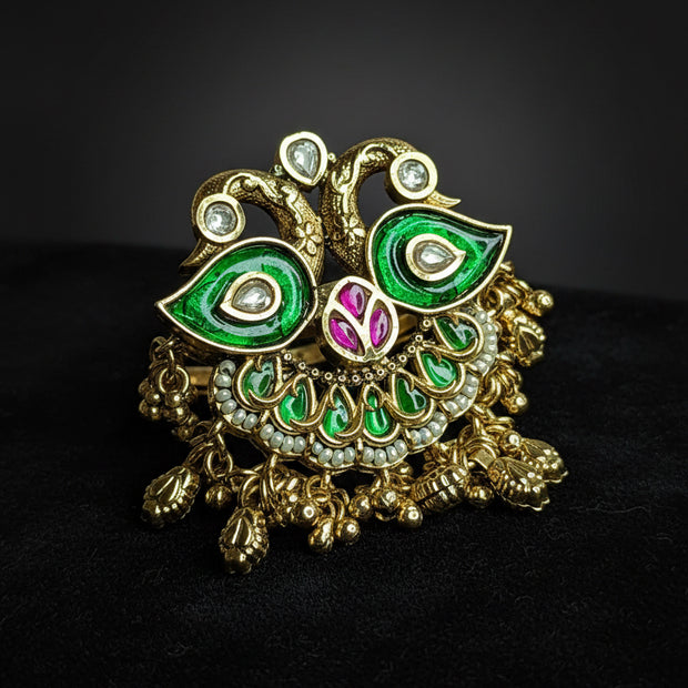  peacock-shaped brooch with green and gold colors 
