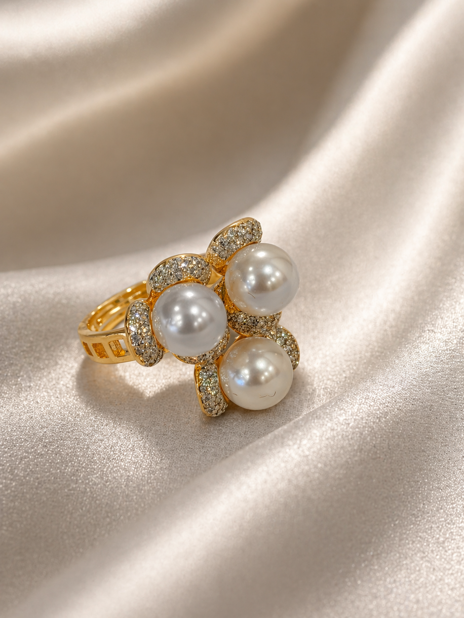 Gold ring with pearls on a satin surface
