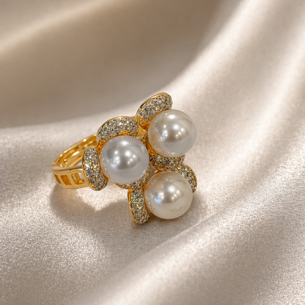 Gold ring with pearls on a satin surface