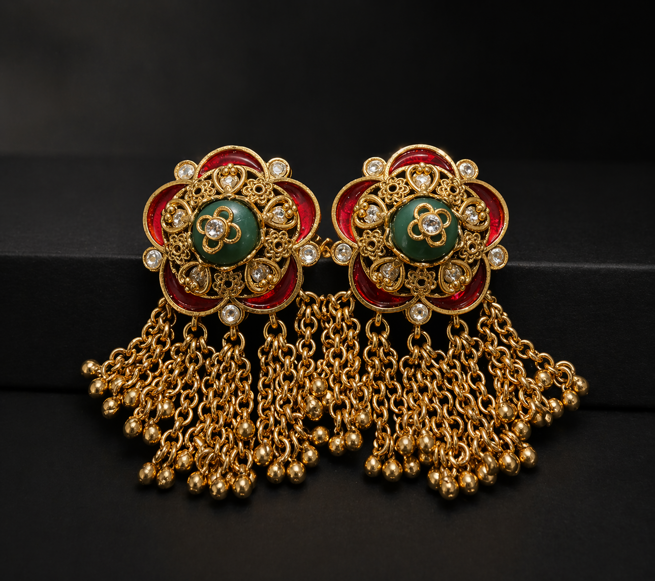 Ornate gold earrings with green 
