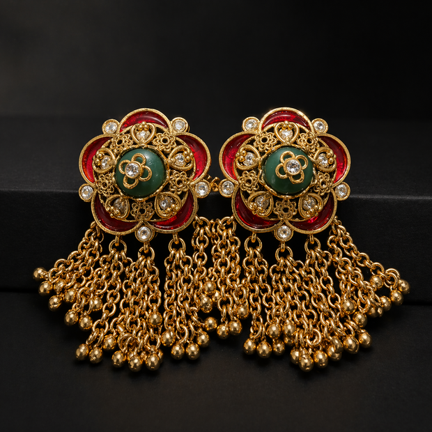 Ornate gold earrings with green 