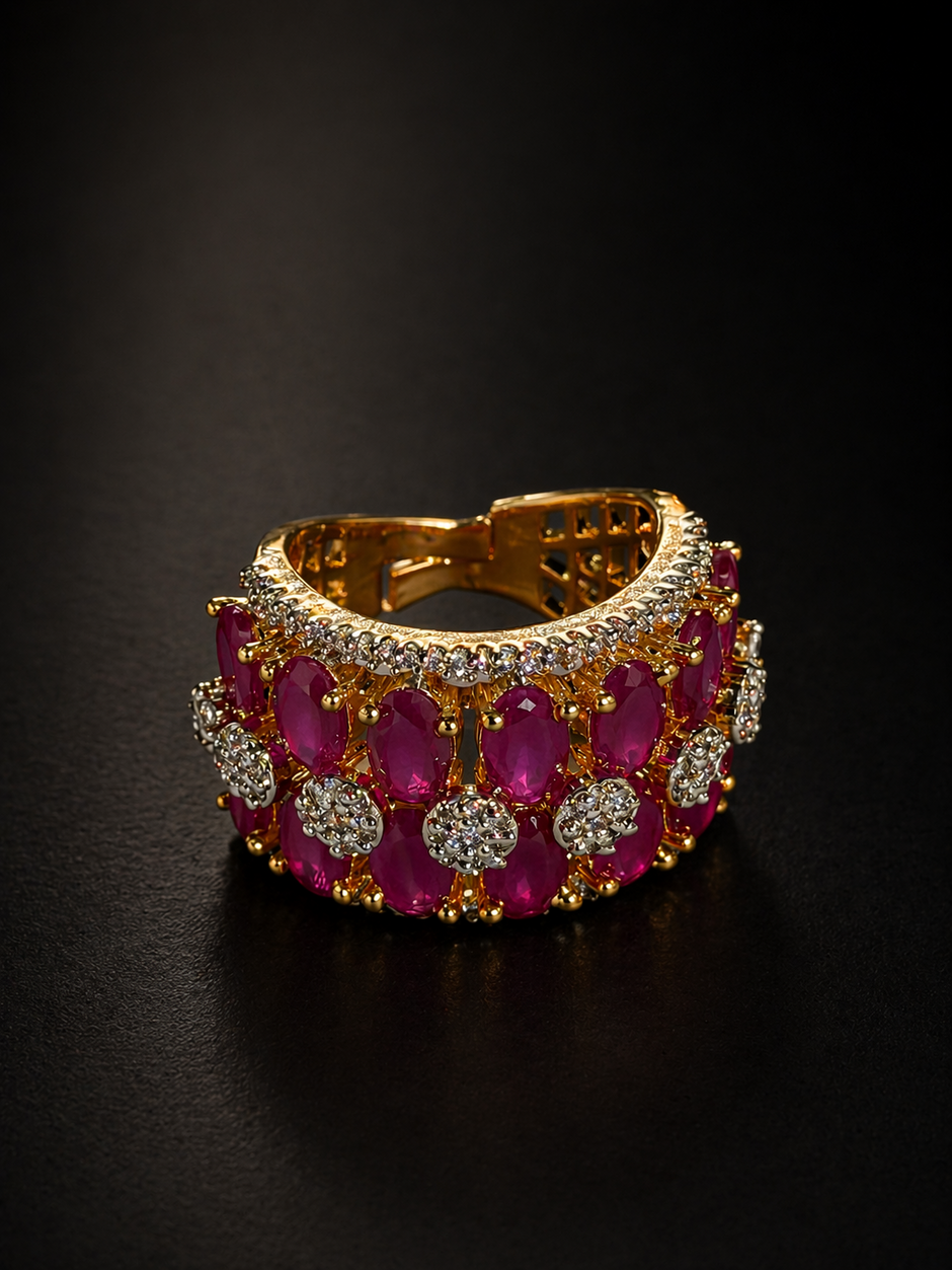 Gold bracelet with red gemstones