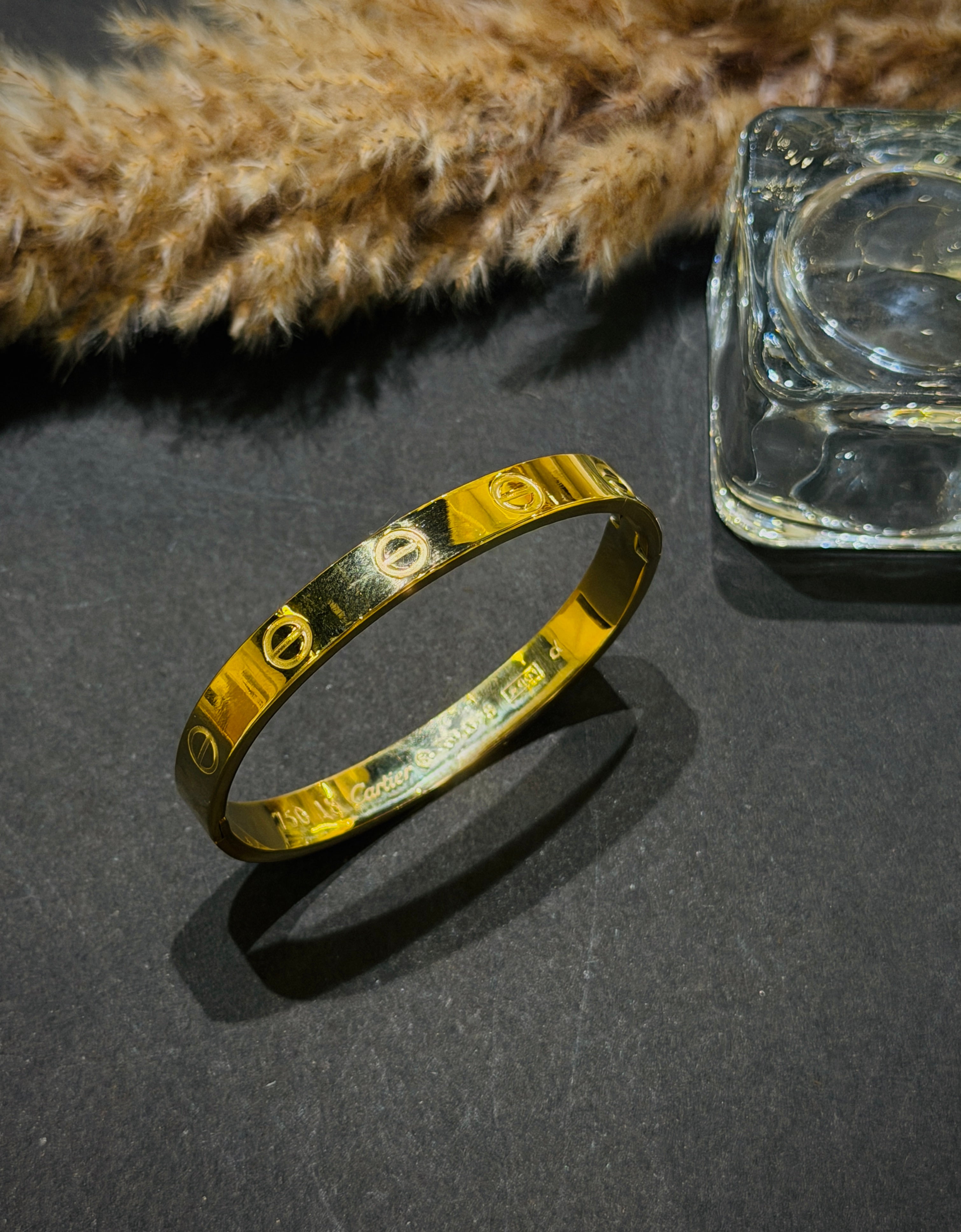 Gold bracelet on a dark surface 