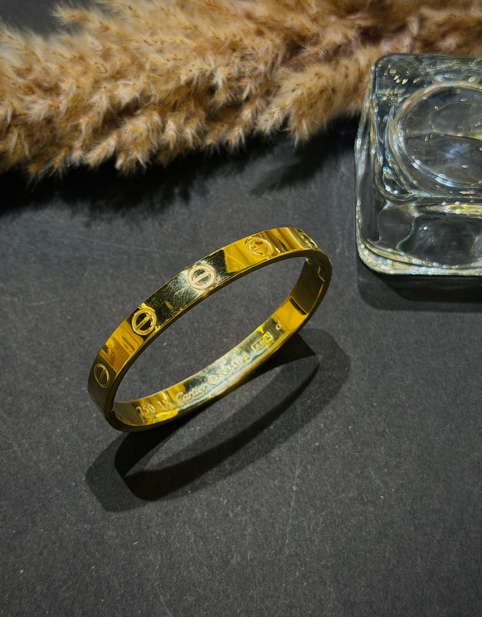 Gold bracelet on a dark surface 