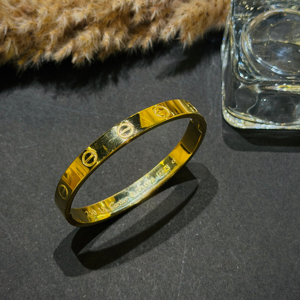 Gold bracelet on a dark surface 