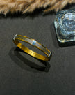 Gold bracelet with blue gemstone 
