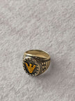 Gold ring with a black and gold emblem 