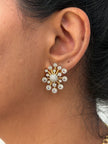 wearing a gold and diamond earring.