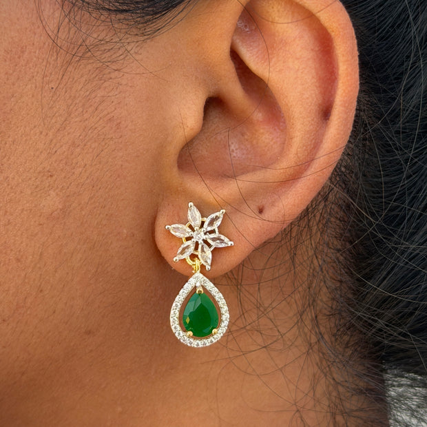  earring with a green teardrop gemstone.