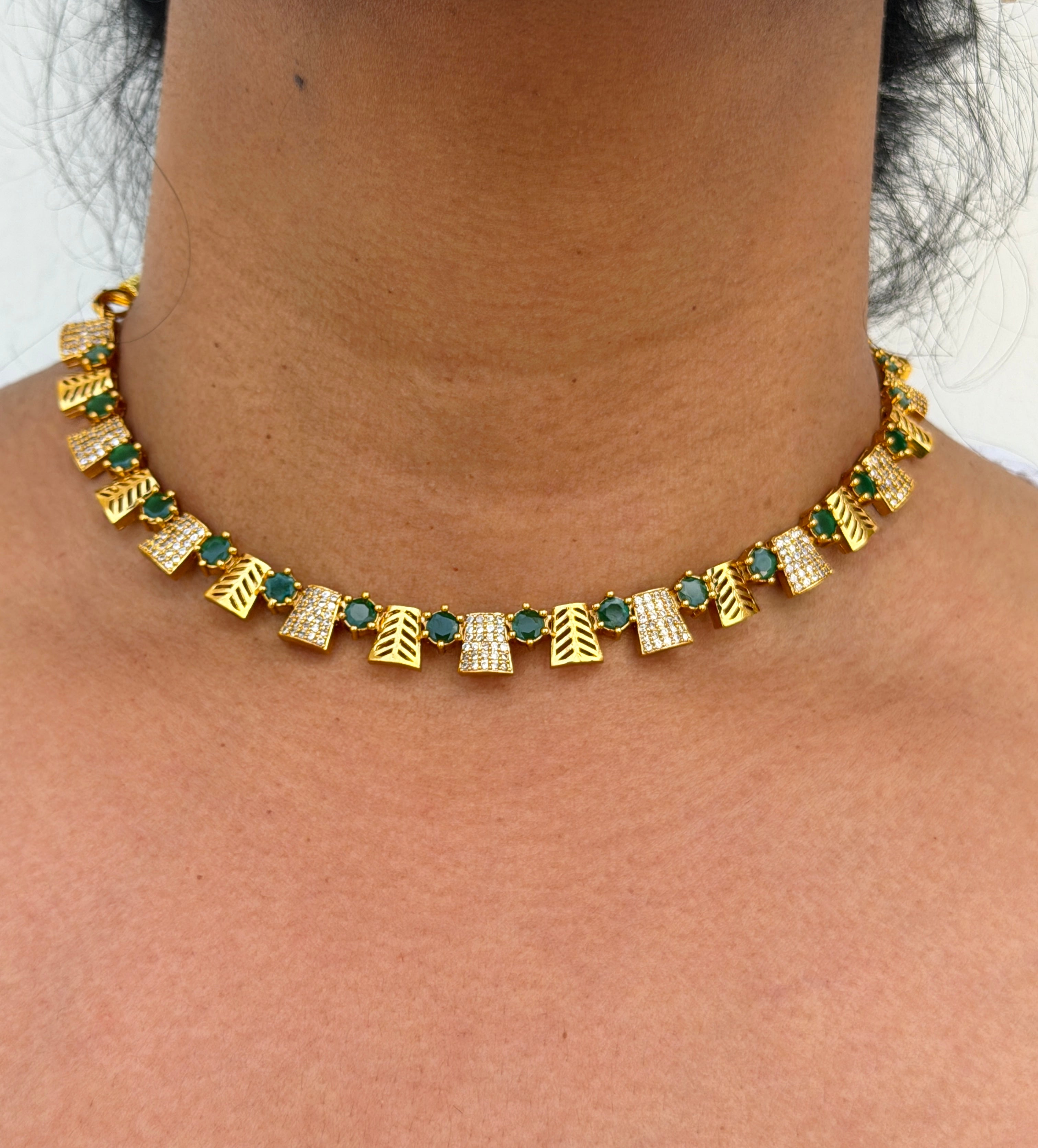 Gold necklace with green and white stones 