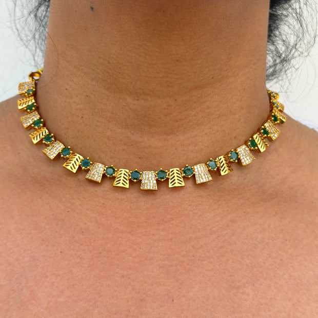 Gold necklace with green and white stones 