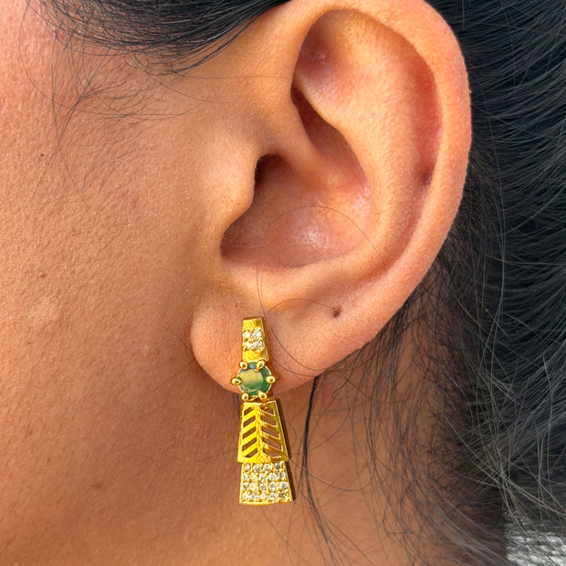 Gold earring with green gemstone 