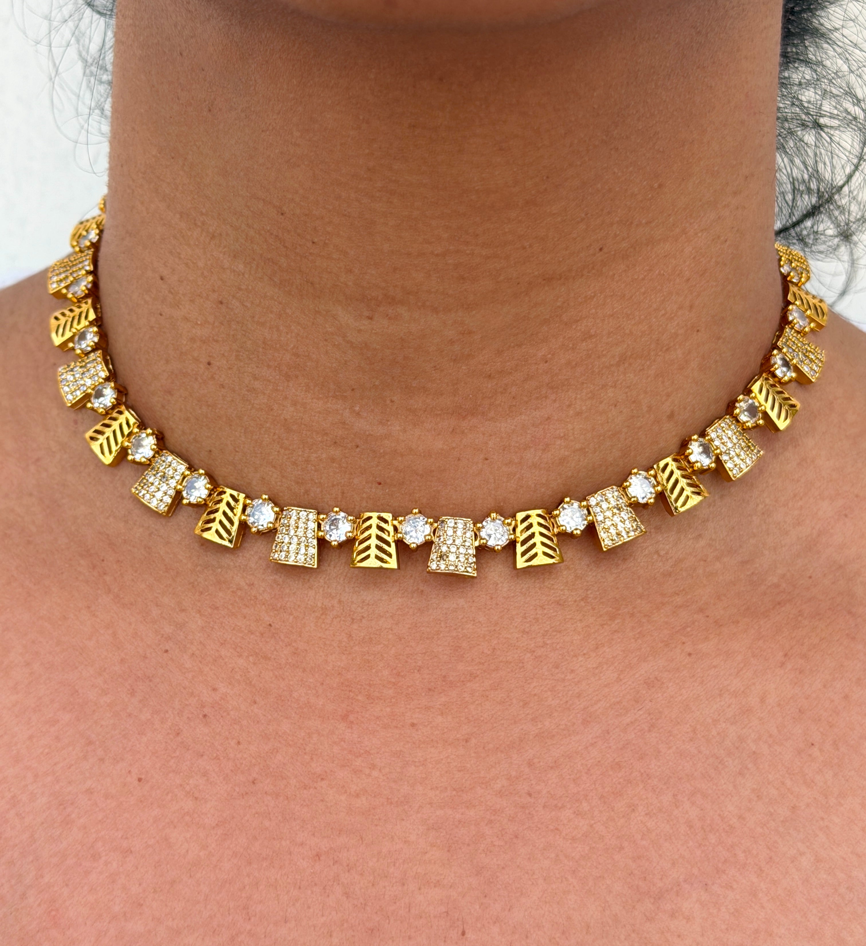 Gold necklace with geometric designs 