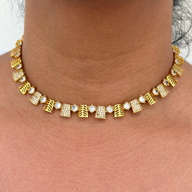 Gold necklace with geometric designs 