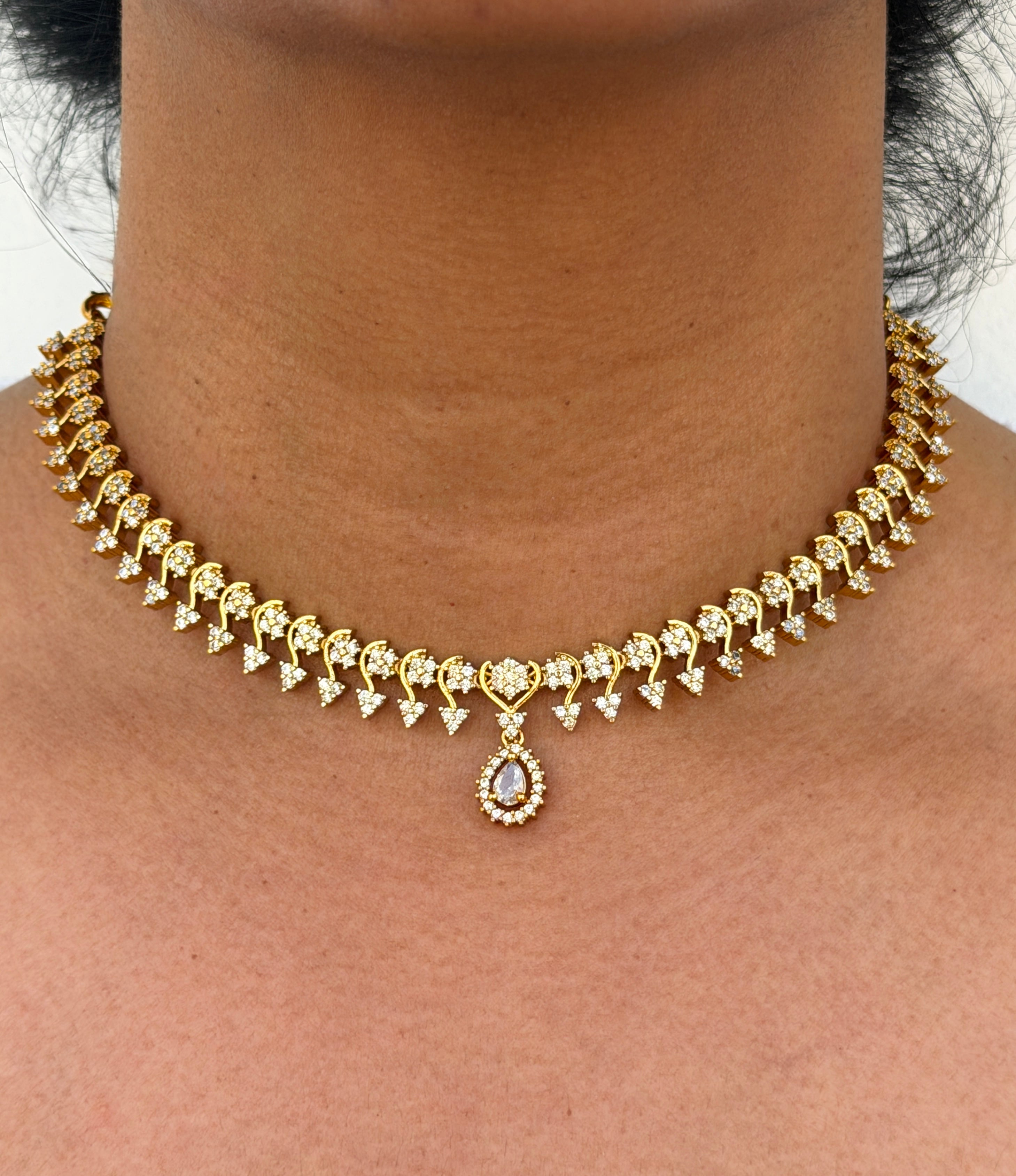 Gold necklace with white stone