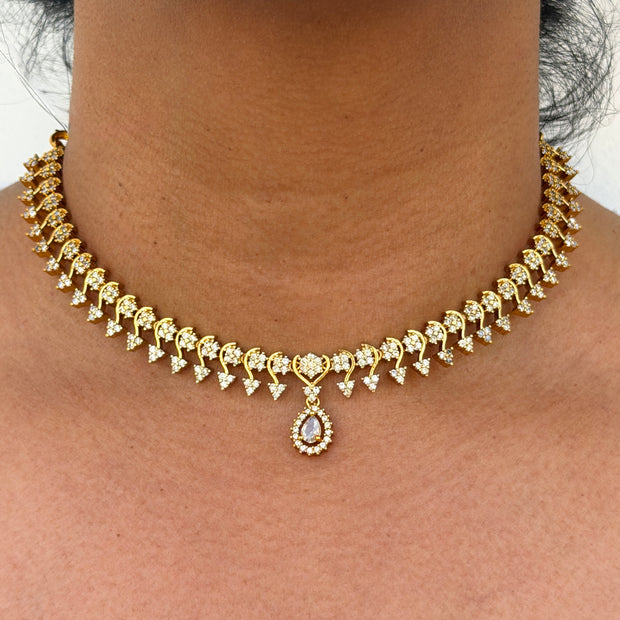 Gold necklace with white stone