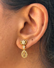 Gold earring with a white gemstone 