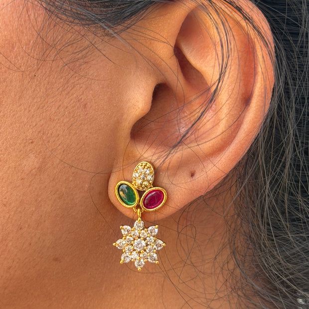 ear wearing a gold earring 