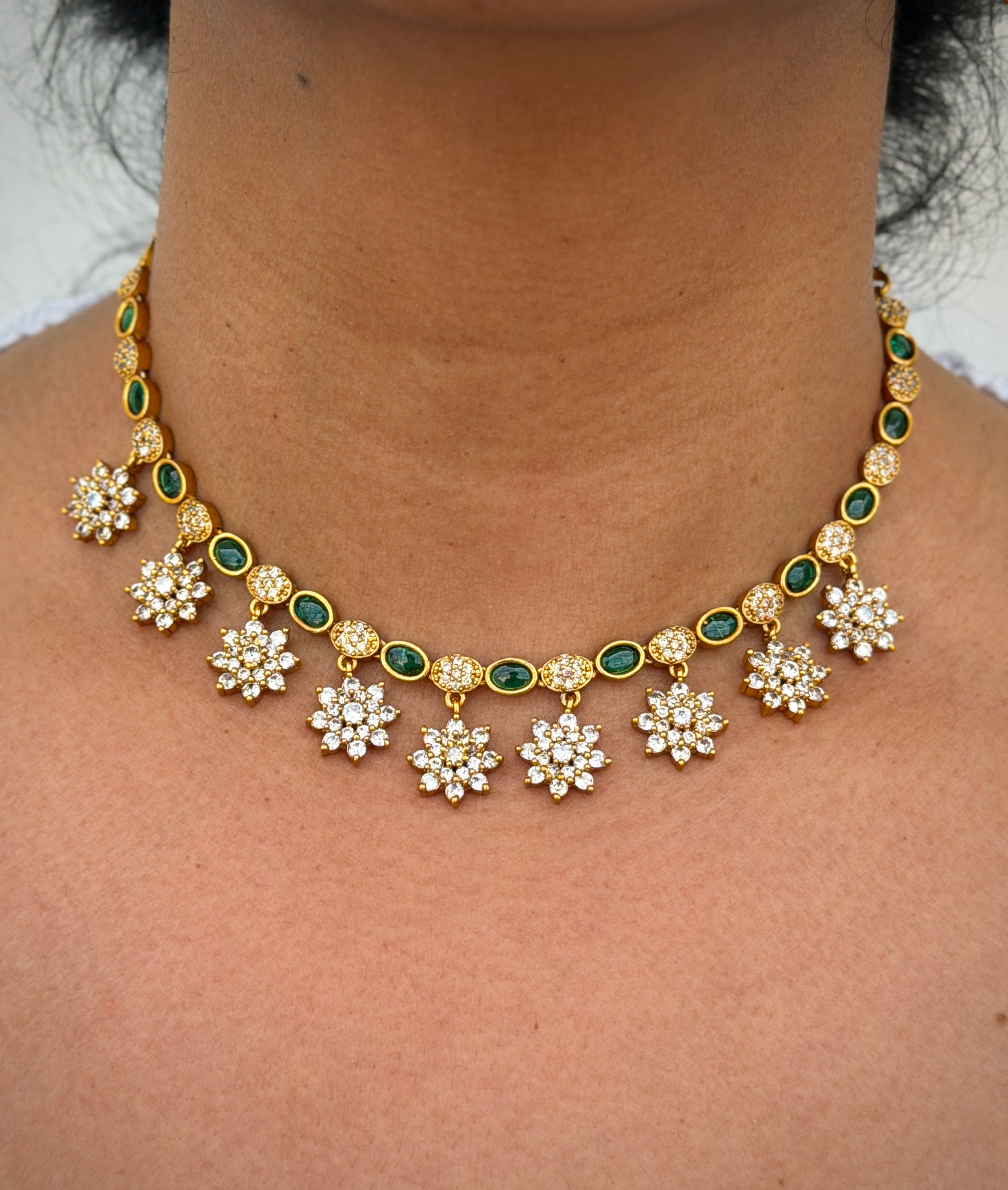 Gold necklace with floral designs 