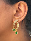 Gold earrings with green gemstones