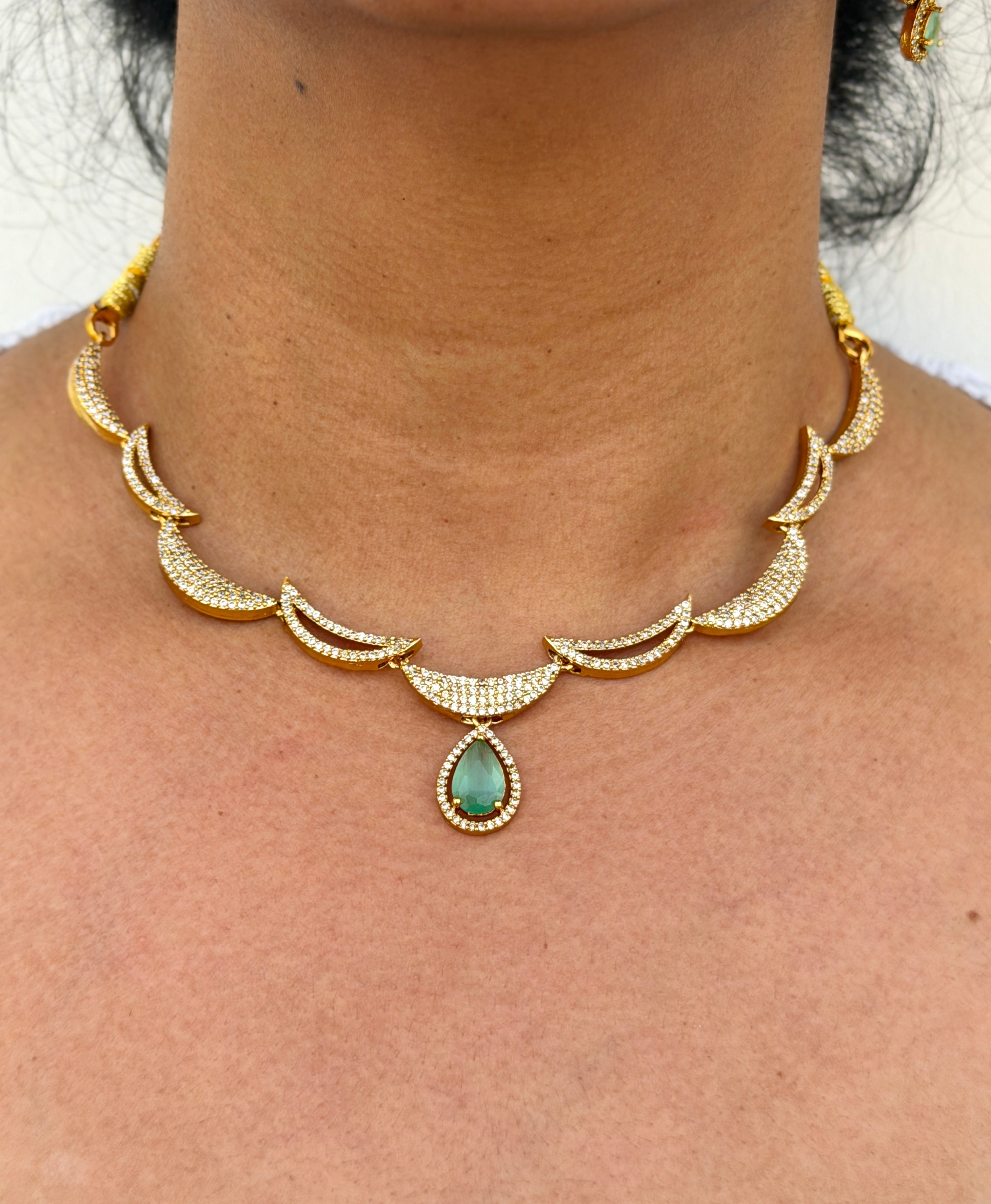 gold neklace with green stone