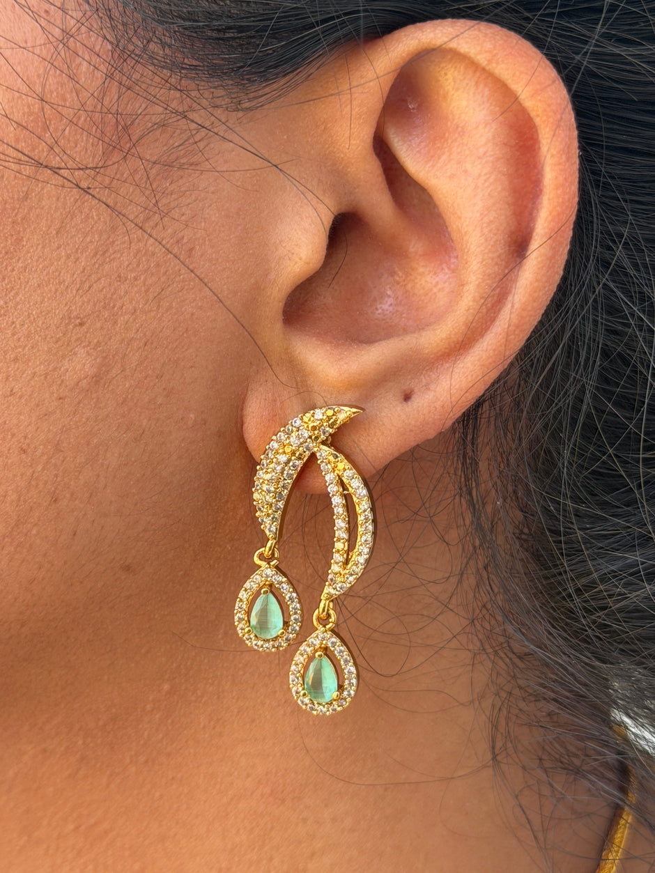 gold earring with green stone