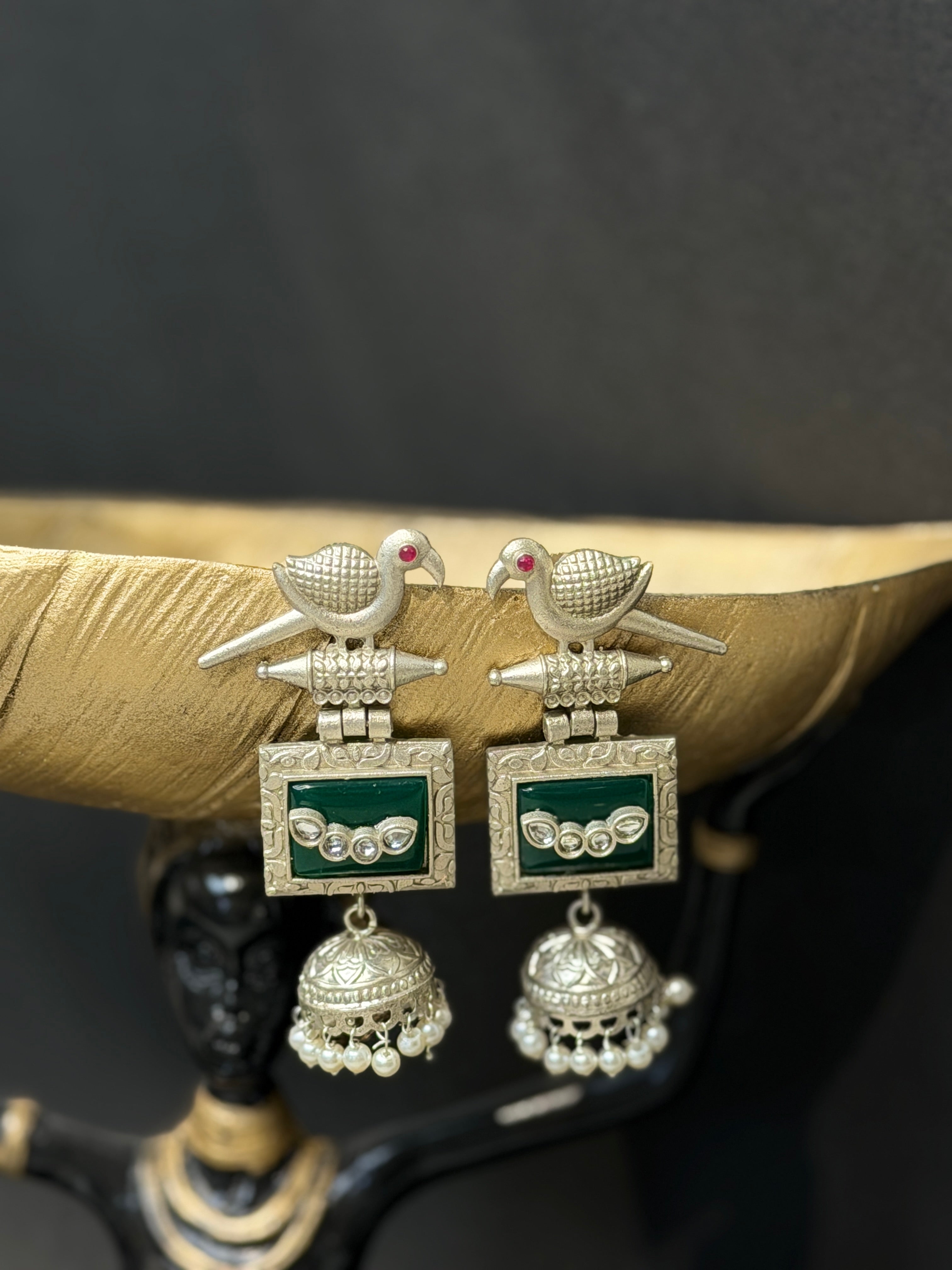 Pair of silver earrings with green accents