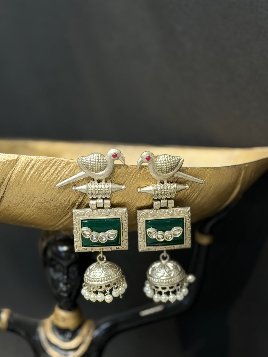 Pair of silver earrings with green accents