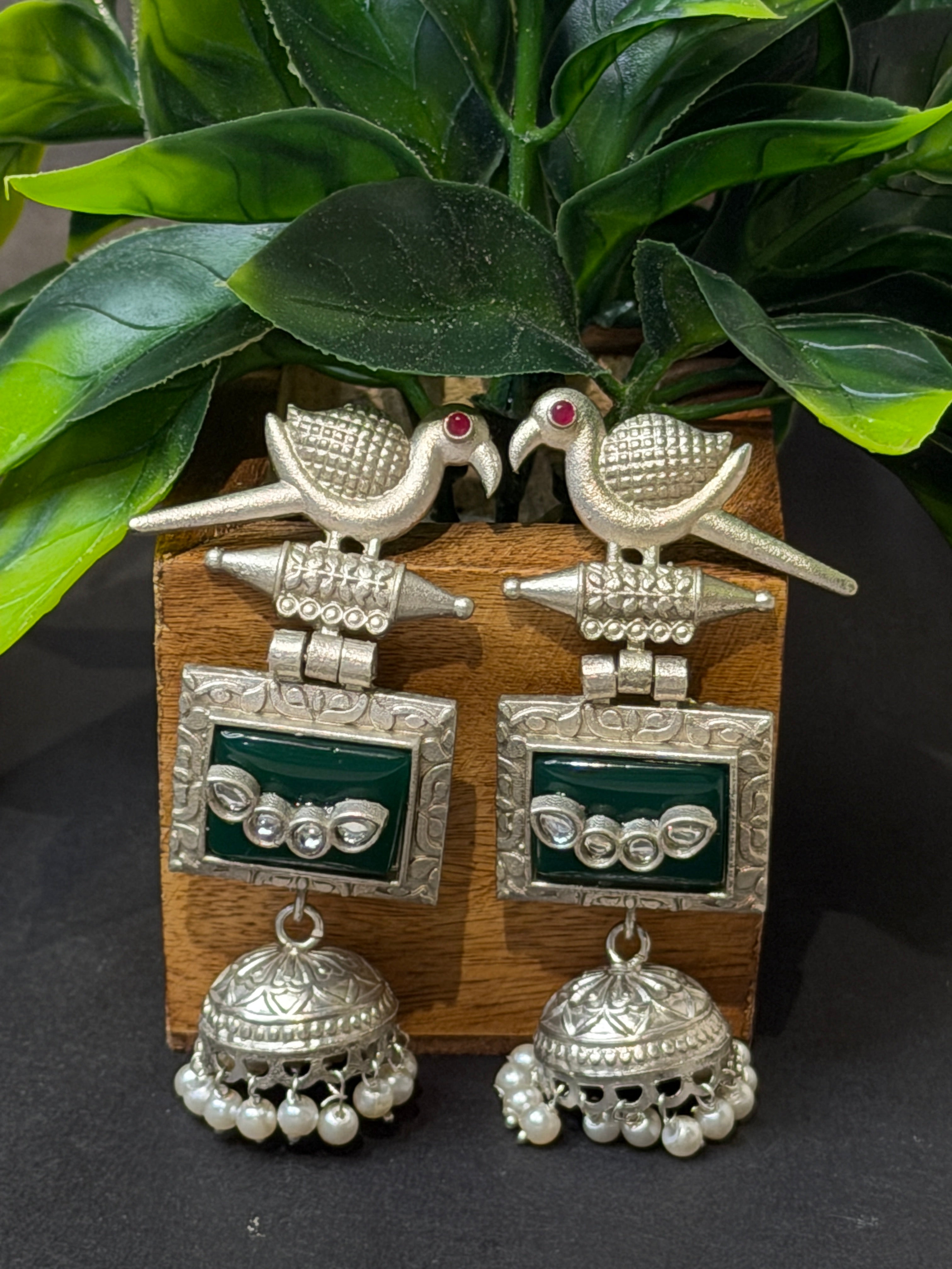 Pair of silver earrings with green gemstones 